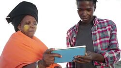 Close up African woman discusses over digital tablet with young man Stock Footage