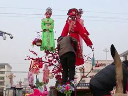 MS TD Man unfasten children dressed as ancient figures attend parade after shehuo celebrations, Shehuo is traditional festive folk celebration during chinese spring festival / xi'an, shaanxi, china Stock Footage