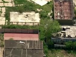 Long Shot aerial tracking-left zoom-in zoom-out - Apartment buildings lie in ruins in the aftermath of Hurricane Katrina in New Orleans. / New Orleans, Louisiana, USA Stock Footage