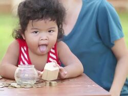 Cute boy with mother learn to count money Stock Footage