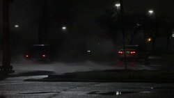 Cars driving through steam from manholes, night Stock Footage