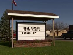 Slow zoom in to sign that reads: Beet Season.  Drive safely.  Buckle up! Stock Footage
