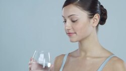 Portrait of young woman drinking a glass of water Stock Footage