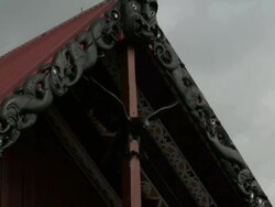 Pan down from traditional Maori roof to government Stock Footage