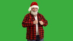 adult senior beard man dancing  in a hat santa claus  on a green background Stock Footage
