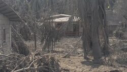 Damaged houses and roads covered in ash after volcano eruption News Clip
