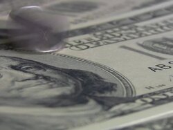 Quarter coin spinning over hundred dollars bill. Currency. Finance. Money. Stock Footage