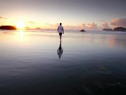 WS SLO MO POV View of teen boy walking on beach at Sun setting / Bandon, Oregon, United States Stock Footage