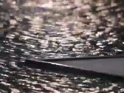 CU LD Light Reflecting on Water Flowing Around Corner of Platform Stock Footage