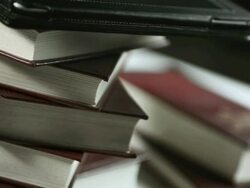 HD: Digital Tablet Against Printed Book Stock Footage