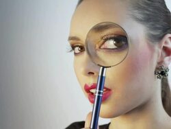 Woman looking through a magnifying glass Stock Footage