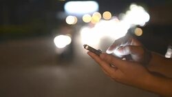 HD:Woman touching smartphone at night time Stock Footage
