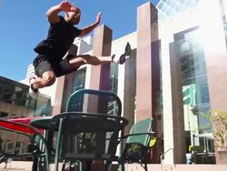 Man runs and leaps over a table Stock Footage