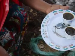 Ethiopian woman putting coffee cups on a tray to serve Stock Footage