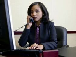 Bank manager using computer and answering telephone Stock Footage