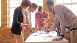 Creative business people reviewing proofs in meeting Stock Footage