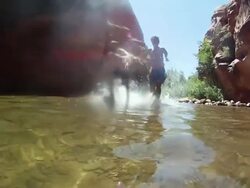 POV of young men running and diving into a river. - Slow Motion - Model Released - HD Stock Footage