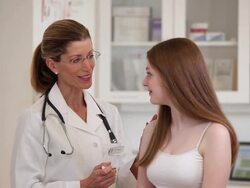 MS Doctor Giving Vaccination to Teenage Patient in Medical Office / Richmond, Virginia, USA Stock Footage