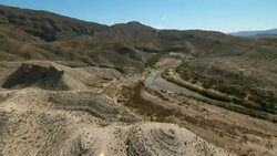Near Mariscal Canyon in Big Bend National Park, the Rio Grande winds through the desert with reduced water levels. Stock Footage