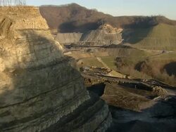 Wide Shot aerial push,in , Narrow dirt roads wind around a coal strip mine operation. / West Virginia Stock Footage