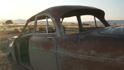 An abandoned car sits in the Namib Desert. Stock Footage
