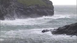 Ocean waves crash against rugged cliffs. Stock Footage