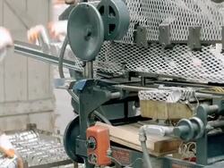 workers pick up freshly sealed cans of olives and place them on intake tray of vintage labeling machine at olive processing plant / Ontario, California, USA  Stock Footage