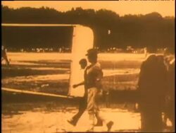 Orville and Wilbur Wright make preparations to take off in their biplane. Stock Footage