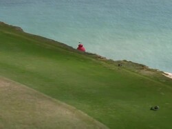 Aerial towards lighthouse off coast of Beachy Head in English Channel / East Sussex, England Stock Footage