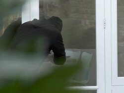 Burglar breaking into house and stealing laptop Stock Footage