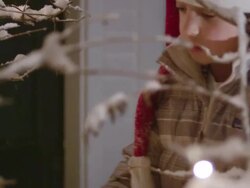 CU Shot of little boy setting lights on outdoor Christmas tree / Yarmouth, Maine, United States Stock Footage