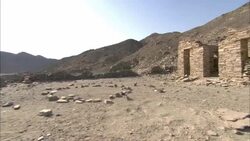 Rocks form a circle on the ground near crumbling ruins in the hills of Shenshef, Egypt. Stock Footage