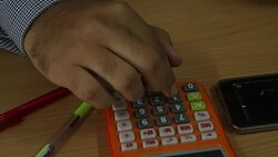 Businessman analyzing data on mobile and calculate Stock Footage