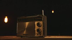 Old transistor 3-band radio under vintage light bulbs Stock Footage