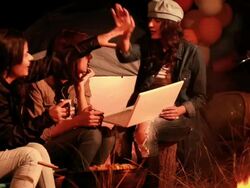 Three young women using laptop in the forest, Delhi, India Stock Footage