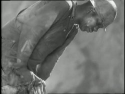 The Tennessee Valley Authority construction workers use hand tools and heavy equipment to build a dam. News Clip