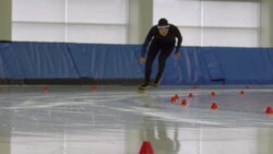MS SLO MO Male long track speed skater racing on track in arena Stock Footage