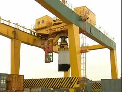 Crane moves and swings NOL container around, Container Terminal, Southampton, UK Stock Footage