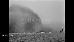 1937: SOUTHERN PLAINS DUST BOWL: HD: WS Plains w/ no vegetation. MS Sand blowing along plain. XWS Dust storm cloud moving toward farm. WS Dust Storm approaching. WS Male running toward farm building w/ Dust Storm cloud BG, Dust Storm Clouds moving. Instructional Video