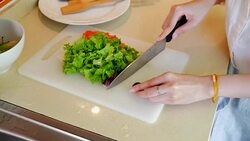 Beautiful chef preparing vegetables for organic salad Stock Footage