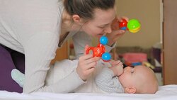 Mom plays with her baby with rattles Stock Footage