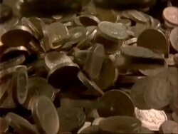 CU High Speed English pound coins fall onto pile of coins Stock Footage