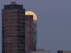 Time Lapse Shot of the moon rising over a building in the Manhattan Skyline in New York City. Stock Footage