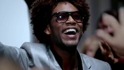 Hip-hop star outside limousine gives peace sign to fans and paparazzi at awards show Stock Footage