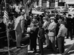 Crowd listening to prejudiced man preaching to crowd on street Stock Footage