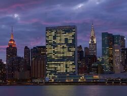 T/L Storm clouds roll above the Empire State Building and the Chrysler Building at sunset Stock Footage