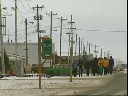 Group of tourists walking through Churchill, Manitoba, Canada Stock Footage