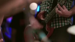 Young man plays guitar in band at crowded rock show Stock Footage