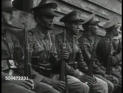 1939: MEXICO SQUARE: EXT VS Mexican soldiers w/ rifles sitting on cabin porch. HA WS Town square, buses, traffic, pedestrians. WS Cars driving, buildings BG. VS People crowded outside of 'Camara de Senadores' entrance. Instructional Video