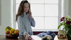 Woman on phone with keys and jacket Stock Footage